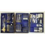 A canteen of silver-plated cutlery, twelve-place setting, in three-drawer oak canteen, on associated