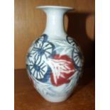 A studio pottery vase decorated with stylised flowers by Marianne de Trey, maker's impressed mark,