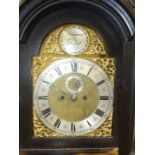 A 19th century stained oak longcase clock, the carved case with arched brass dial, second subsidiary