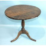 An 18th century oak circular table with birdcage action and turned column on tripod feet, 71cm