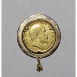 An Edward VII sovereign, 1904, in 9ct gold engraved pendant mount, 10.4g.