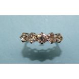 A five-stone diamond ring claw-set five graduated old brilliant-cut diamonds, in 18ct white gold and