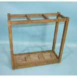 A Cotswold School oak umbrella stand complete with three galvanised drip pans, 60cm high, 61cm wide,