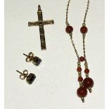 A 9ct gold necklace with bead tassel, a 9ct gold cross pendant and a pair of garnet ear studs.