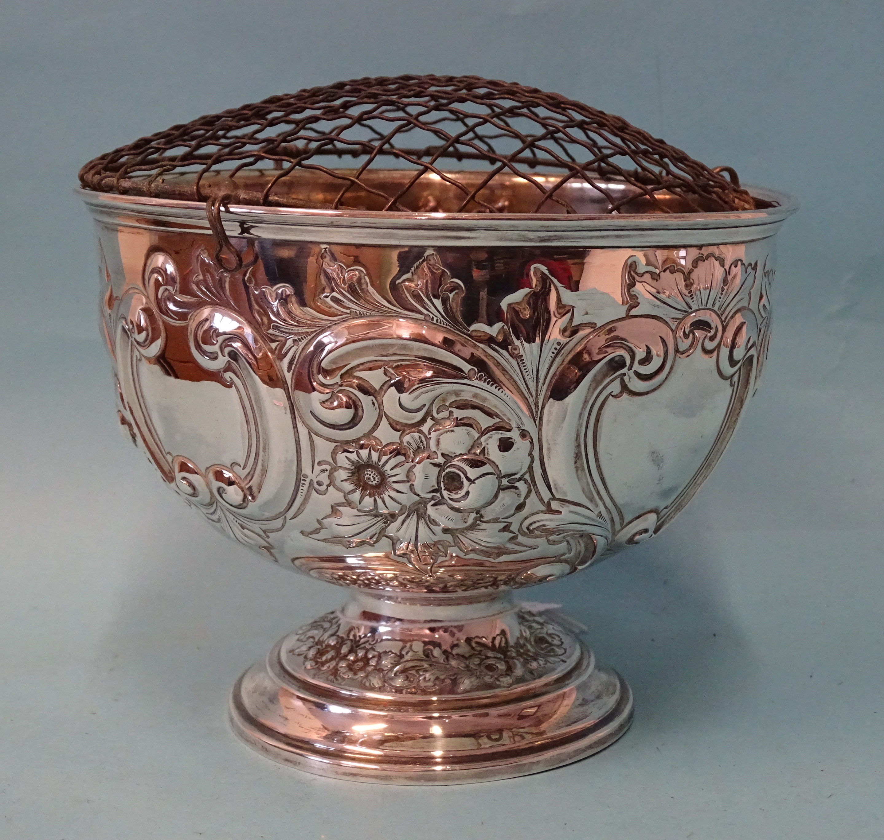 An Edwardian silver pedestal rose bowl with embossed flower and scroll decoration, maker Lee &