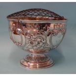 An Edwardian silver pedestal rose bowl with embossed flower and scroll decoration, maker Lee &