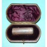 A late-Victorian silver-cased smelling salts bottle of cylindrical form, with engraved decoration