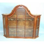 An 18th century Dutch walnut hanging glazed display cabinet, having a single arched, glazed door and
