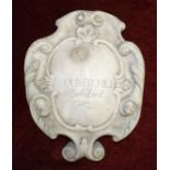 A white marble scroll-form cartouche inscribed Oliver Hill Architect, 43cm x 34cm. Oliver Hill (