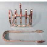 A small four-division silver toast rack, Sheffield 1918 and a pair of Georgian silver sugar tongs,