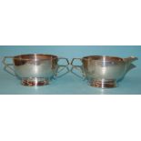 A silver milk jug and sugar bowl of squat form, maker DF, London 1930, 5cm high, 8.5cm diameter,