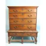 An 18th century oak chest of four drawers on stand, with one drawer, on turned legs, 97cm wide,