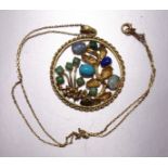 A yellow metal circular pendant with flowers and leaves set jade, opals, turquoise and lapis lazuli,