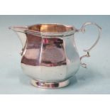 A small silver cream jug of octagonal bellied form, with scroll handle, 6.5cm high, London 1905,