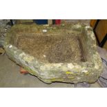 A Cotswold stone trough of rectangular form, with one chamfered corner, 86 x 60cm.