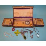 An Edwardian leather jewellery case with silk lining (lining a/f) and a small collection of