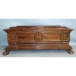 A 16th/17th century Italian walnut cassone of sarcophagus shape, the panelled front divided by