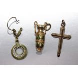 A small gold and enamel charm in the form of an urn, marked 'K18', 3.1g, a 9ct gold cross, 1.3g