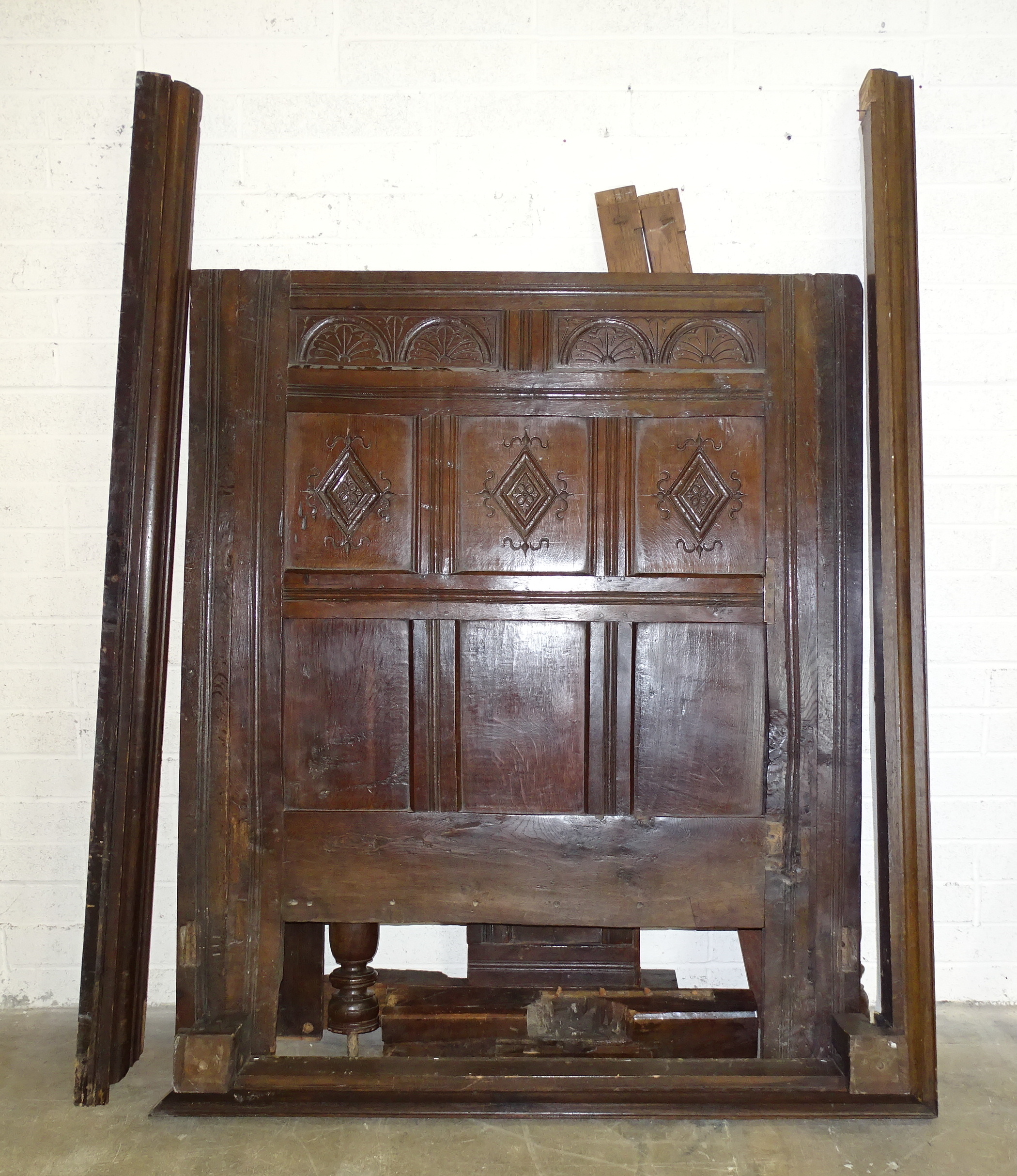 Parts of an antique oak carved four-poster bed, together with a pair of posts from another bed, (2).