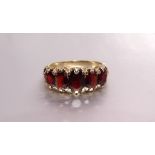 A 9ct gold ring set five graduated garnets, size P, 3.7g.