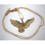 A 9ct gold pendant in the form of an eagle, on 9ct gold neck chain, pendant 4.4cm across, chain 50cm