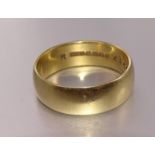 An 18ct gold wedding band, 7mm wide, size V, 7.9g.