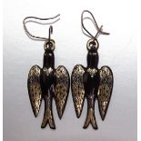 A pair of Victorian tortoiseshell piqué earrings in the form of birds, with inset gold and silver
