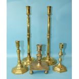 A pair of brass 19th century tall candle holders on turned circular bases, 43cm high and three other