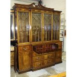 A reproduction inlaid mahogany breakfront bookcase, the cornice above four astragal-glazed doors,