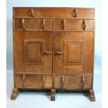 An Edward Barnsley side cabinet having an arrangement of five drawers and a pair of central cupboard