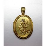A Victorian yellow metal oval locket with applied monogram, (now detached), 45mm overall, 14.4g.