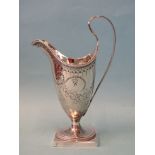 A George III silver cream jug of helmet shape with reeded handle, on pedestal foot with square base,