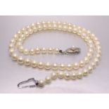 A string of graduated cultured pearls with silver clasp, 4.5 - 5.5mm, 44cm long.