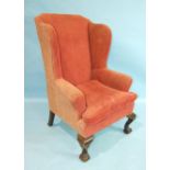 A 19th century Georgian-style upholstered wing armchair on cabriole front legs with claw and ball
