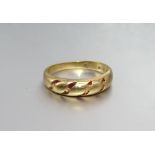 An 18ct gold ring, originally with enamelled striations, size L, 3.2g.