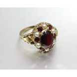 A modern 9ct gold garnet and pearl cluster ring, size O, 4g.