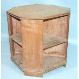 An octagonal oak book table, 67cm wide, 63cm high, possibly Heals.