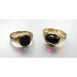 An 18ct gold ring set foiled garnet cabochon, size M, 4.2g and a small 9ct gold signet ring set