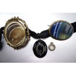 A dyed banded-agate brooch, in metal mount, a gilt metal hair locket brooch, a mourning locket inset