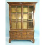 A 17th/18th century walnut and oak glazed display cabinet, having a pair of glazed doors, three