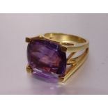 A modern amethyst dress ring, in yellow gold mount bearing foreign marks, tests as 18ct gold