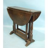 An antique oak oval drop-leaf gate-leg table on turned end supports and plain gate legs, 74 x 88cm