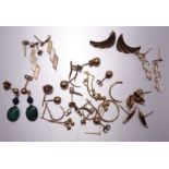 Seven pairs of 9ct gold earrings, 4.4g and other unmarked earrings, gold fragments, etc.