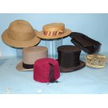 A moiré silk opera top hat, a "1928" pith helmet, a Ridgmont straw boater, a mortarboard, a G A Dunn