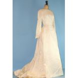 Harrods, a vintage wedding dress, c1958, of ivory brocade, with boat-shaped neckline, fitted long