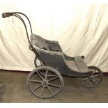 A late-Victorian coach-built invalid carriage, the wood and buttoned upholstered seat on sprung