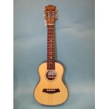 A Kmise ukulele with soft case and a Brunswick Rodeo series acoustic guitar, model BMT105-AF, (2)