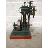 An iron and copper vertical steam operating plant, on wood base, 42cm high.