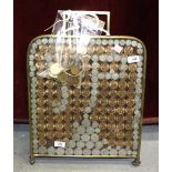 A collection of British coinage contained in a brass-framed fire screen, most of the coins stuck-