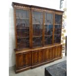 A reproduction Georgian-style mahogany breakfront bookcase, the cornice above four astragal-glazed